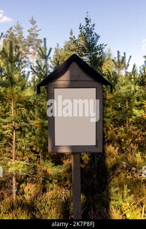 Vuoto segno bianco in natura, con alberi verdi sullo sfondo Foto Stock