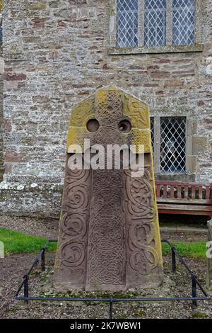 La Vista Ovest della pietra scolpita di Aberlemno 2 nel Kirkyard della chiesa locale, con la sua croce celtica scolpita in una lastra di arenaria rossa. Foto Stock