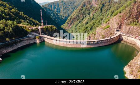 Fotografia aerea della diga di Vidraru, in Romania. La fotografia è stata scattata da un drone dall'alto del lago Vidraru con la diga nella vista. Foto Stock