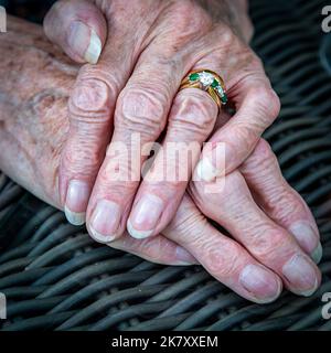 Una vista ad angolo alto di una donna anziana con una mano sopra l'altra Foto Stock