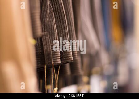 Primo piano sulla selezione di sfondo motivo tessile per pantaloni uomo, non sono visibili persone. Foto Stock