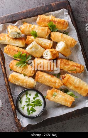 Sigara boregi è una famosa pasta fritta turca croccante panini di pasta sottile sono ripieni con una cremosa miscela di formaggio e prezzemolo closeup. Verticale Foto Stock