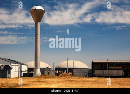 Impianto di biogas simbolo di energia alternativa con torre d'acqua Foto Stock