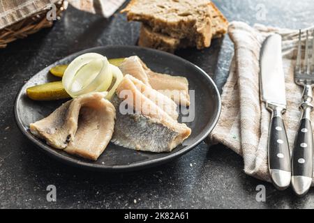 Pesce d'aringa marinato sul piatto. Foto Stock
