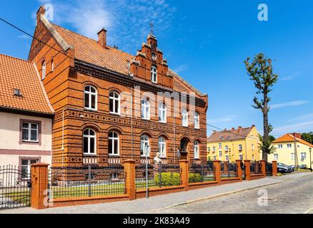 Bartoszyce, Polonia - 13 luglio 2022: Casa di vicariato gotico della chiesa di San Giovanni Evangelista Kosciol SW. Jana Ewangelisty nel centro storico della città Foto Stock