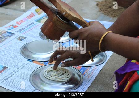 Preparare il riso del sud indiano Murukku fatto in casa per gli spuntini del festival Diwali in modo tradizionale Foto Stock