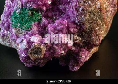 Calcite Cobalto con macro cristallo di malachite su una superficie nera Foto Stock