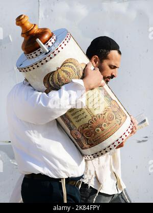 Un uomo ebreo ortodosso che tiene i libri di Torah al Muro del Pianto a Gerusalemme. Foto Stock