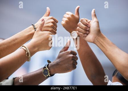 Amiamo quello che youre fa. Primo piano di un gruppo di uomini d'affari irriconoscibili che mostrano pollici in su. Foto Stock