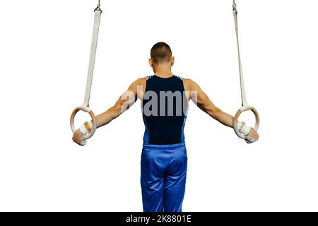 gli anelli di esercitazione dell'atleta di ginnastica ancora Foto Stock