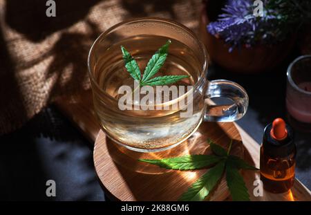 Una tazza di tè di cannabis a foglia fresca Foto Stock
