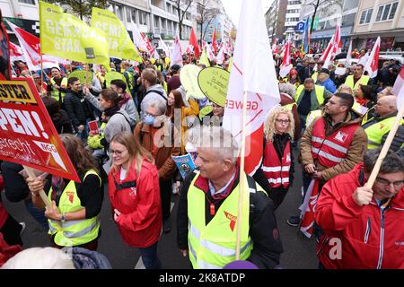 Duesseldorf, Germania. 22nd Ott 2022. Durante la dimostrazione, i partecipanti con bandiere camminano lungo una strada. Il rally è accompagnato dalla polizia. Un'alleanza sociale ha richiesto dimostrazioni a livello nazionale, chiedendo ulteriori misure di soccorso efficaci a breve termine, un tetto massimo per il prezzo dell'elettricità e del gas, ulteriori sussidi per l'energia e la fine della dipendenza dai combustibili fossili. Credit: David Young/dpa/Alamy Live News Foto Stock