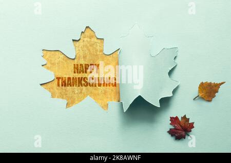 Foglio di autunno taglio di carta che rivela il ringraziamento felice sotto Foto Stock