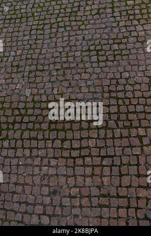 Blocco pietra pavimento struttura sfondo pietra blocco strada pavimentazione. Particolare di strada acciottolata, grunge muro di granito struttura Foto Stock