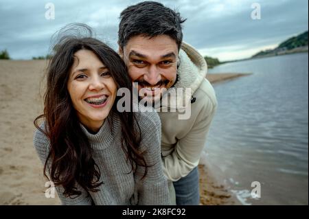 Coppia felice che si diverte a riva del fiume Foto Stock