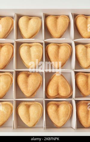 Biscotti a forma di cuore disposti nella scatola Foto Stock