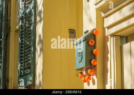 NEW ORLEANS, LA, USA - 22 OTTOBRE 2022: Stringa di piccole luci Jack -o'-lanterna di plastica che decorano una cassetta postale sul telaio della porta della casa storica Foto Stock