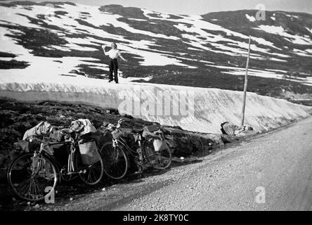 Norvegia, estate 1943 vita quotidiana durante la guerra. I permessi di viaggio erano difficili da raggiungere durante la seconda guerra mondiale, motivo per cui molti hanno scelto una bicicletta. Una giovane coppia ha affrontato il tratto Oslo / Ålesund. Sull'alta montagna c'era una breve sosta per salutare la neve. Foto: NTB Foto Stock