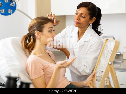 Donna che ha consultazione alla clinica di medicina estetica Foto Stock