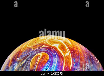 Spazio di realtà virtuale con un pianeta psichedelico astratto multicolore. Closeup bolla di sapone come un pianeta alieno su sfondo nero Foto Stock