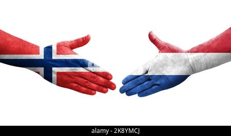 Stretta di mano tra Paesi Bassi e Norvegia bandiere dipinte sulle mani, immagine trasparente isolata. Foto Stock