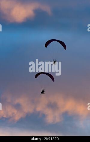 Un paio di parapendio a motore che volano al tramonto vicino a Hanksville, Utah. Foto Stock