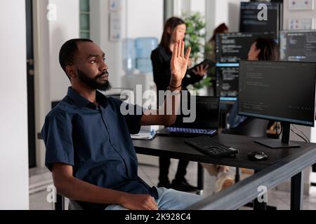 Sviluppatore di software che analizza ar ologramma per lavorare su codice html, utilizzando l'interfaccia di database olografico con realtà aumentata. Programma di cloud computing con finestra terminale nell'ufficio dei big data. Foto Stock