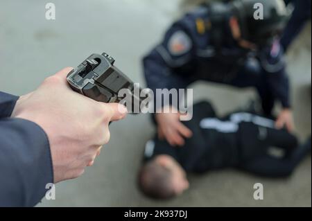 I cadetti degli studenti dell'Accademia di polizia serba si allenano nelle tattiche di base della polizia/applicazione della legge utilizzando le pistole e arrestando un sospetto Foto Stock