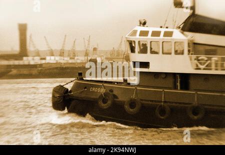 Vintage Liverpool 1969, rimorchiatore sul fiume Mersey, attracca Birkenhead sullo sfondo. Effetto grana grossa. Foto Stock