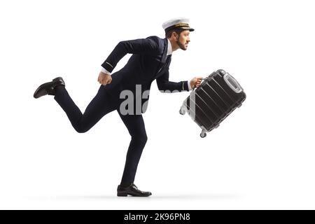 Profilo a tutta lunghezza girato di un pilota in fretta con una valigia e corsa isolata su sfondo bianco Foto Stock