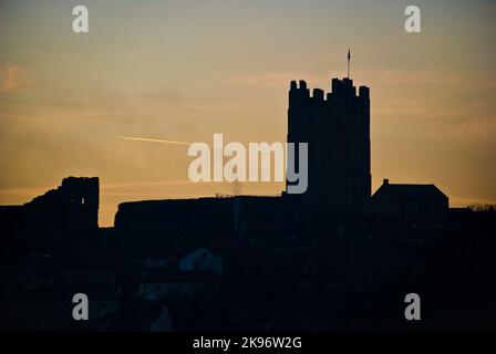 Silhouette del castello di Richmond al tramonto. Il fumo sale dal camino in primo piano. Airliner attraversa il cielo sullo sfondo Foto Stock
