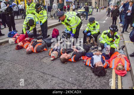 Londra, Regno Unito. 27th Ott 2022. Gli agenti di polizia arrestano i manifestanti durante la manifestazione. Basta fermare gli attivisti del petrolio incollato le mani e si sono bloccati su tubi metallici che bloccano le strade intorno alla Mansion House Station nella City of London, il quartiere finanziario della capitale, mentre continuano le loro proteste chiedendo al governo di smettere di rilasciare nuove licenze per i combustibili fossili. Credit: SOPA Images Limited/Alamy Live News Foto Stock