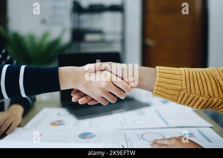 Gli imprenditori asiatici si congratulano con l'accordo tra le due aziende per aumentare gli investimenti e la forza finanziaria. Concetto di trattativa Foto Stock