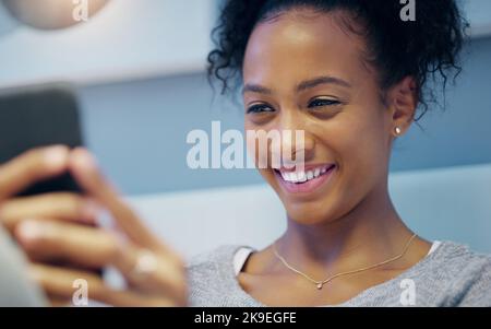 Le chat notturne sono le migliori: Una giovane donna attraente che fa selfie con il suo cellulare mentre si rilassa sul letto di notte. Foto Stock