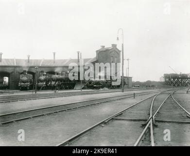 La ferrovia Karlskrona - Växjö è stata aperta al traffico pubblico nel 1874. Nello stesso anno, le case di stazione sono state completate su due piani. Il cortile è stato progettato in modo da avere spazio per cinque piste. La prima locomotiva provvisoria fu costruita già nel 1872 a nord della stazione di Karlskrona. La nuova locomotiva è stata costruita contemporaneamente al nel 1874 Bangården da mattoni e alloggio 6 stalle. Foto Stock