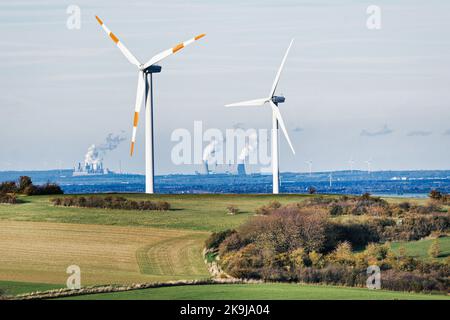 Mechernich, Germania, 26 ottobre 2022: Due turbine eoliche sulle colline rurali di fronte a due centrali elettriche a lignite di RWE Power ag in background Foto Stock