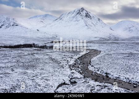 Splendida immagine aerea del paesaggio dei droni di Stob Dearg e Glencoe nelle Highlands scozzesi durante le profonde nevicate e i bellissimi cieli blu Foto Stock