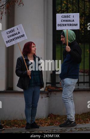 I manifestanti con i segni che indicano "onore e gloria ai disertori" sono visti di fronte all'Ambasciata russa a Varsavia, in Polonia, il 28 ottobre 2022. Sin Foto Stock