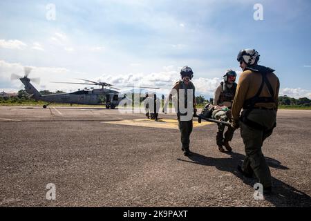 221028-N-VQ841-1319 PUERTO BARRIOS, Guatemala (ott 28, 2022) i marinai, attaccati ai 'Chargers' dello Squadrone di combattimento del Mare dell'elicottero (HSC) 26, e i soccorritori guatemaltechi simulano il trasporto di emergenza del paziente come parte dell'addestramento di Assistenza umanitaria e soccorso di emergenza (HADR) all'aeroporto della Brigata della Fanteria Marina a Puerto Barrios, Guatemala, 28 ottobre 2022. La nave ospedaliera USNS Comfort (T-AH 20) viene distribuita alla flotta degli Stati Uniti 4th a sostegno di Continuing Promise 2022, una missione di assistenza umanitaria e di buona volontà che conduce cure mediche dirette, cure veterinarie di spedizione, e matte soggetto Foto Stock