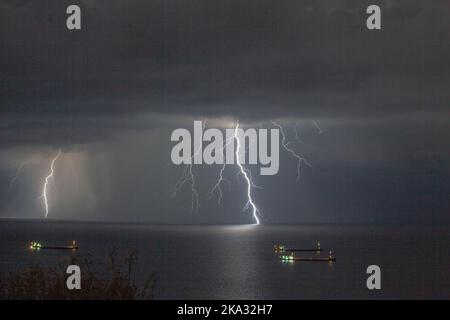 Un fulmine colpisce il mare di Marmara al largo della costa di Tekirdag, Turchia, in un clima nuvoloso Foto Stock