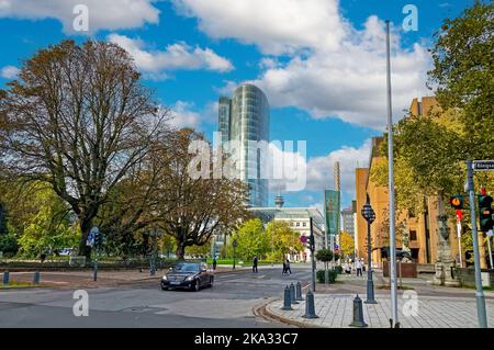 Düsseldorf (Graf Adolf Platz), Germania - Ottobre 9. 2022: Paesaggio urbano con parco verde, moderno edificio a torre Gap 15, cielo blu autunnale Foto Stock