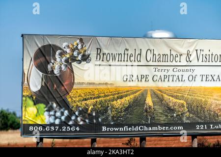 Brownfield, USA - 8 giugno 2019: Texas Countryside Town e segno storica fattoria strada per camera e centro visitatori presso il cartellone della capitale dell'uva dal 380 Foto Stock