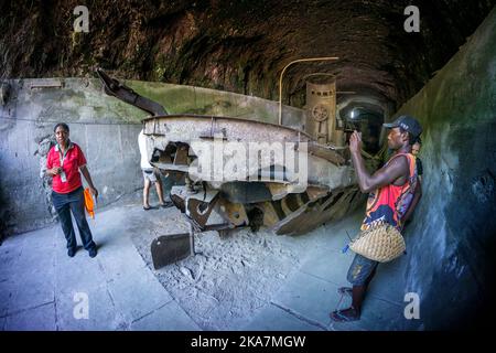 I turisti che visitano i resti del trasporto giapponese della seconda guerra mondiale chiatta nel tunnel chiatta. Rabual, Isola della Nuova Gran Bretagna, Papua Nuova Guinea Foto Stock