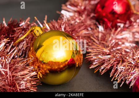 Palla di Natale d'oro per la decorazione sull'albero di Natale e tinsel festivo Foto Stock