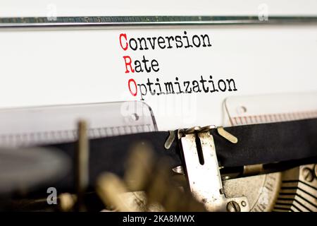 Simbolo di ottimizzazione del tasso di conversione CRO. Concetto parole CRO tasso di conversione ottimizzazione tipizzato su vecchia macchina da scrivere retrò. Sfondo bianco. CRO aziendale Foto Stock