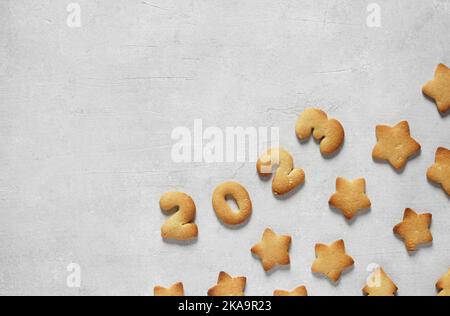 Biscotti sotto forma di numeri 2023 su fondo concreto. Concept nuovo anno, vista dall'alto, spazio copia Foto Stock