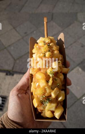 Vista dall'alto, un hot dog in stile coreano, cibo di strada coreano, hot dog con farcitura di patate fritte e salsa di senape al miele. Foto Stock