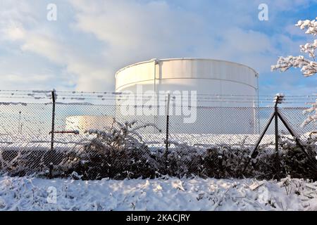 Serbatoi di bianco nel serbatoio fattoria con scala in ferro nella neve Foto Stock