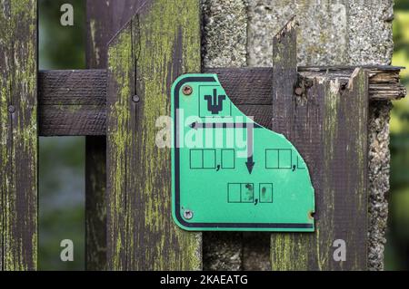 frammento di primo piano di recinzione vecchia e rotta con segno di comunicazione rotto Foto Stock