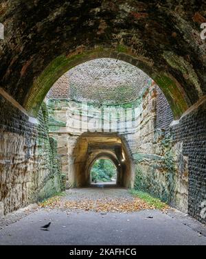 Tunnel del Parco inferiore di roccia non fiancheggiata e albero a metà strada aperto visto da volta fiancheggiata in mattoni e parte di tunnel superiore fiancheggiata in pietra Foto Stock